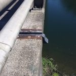 A Kickout Termination extends beyond the edge of the bridge deck and helps to direct water run off beyond the piers below.