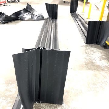 Below-grade expansion joint with factory-welded upturn both ends