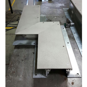 Expansion joint transition with integral cover plate Emseal